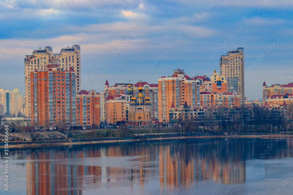 Fototapeta premium View of Obolon embankment of the Dnieper river and church of the Nativity of Christ in Kiev, Ukraine