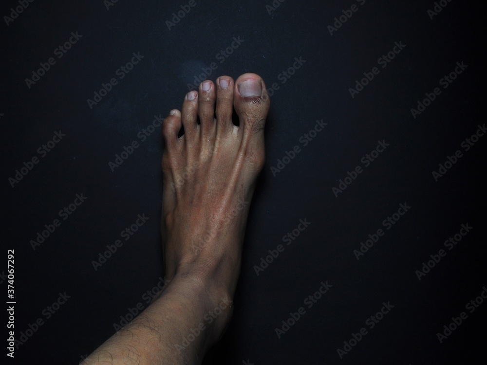 Close-up male feet isolated on black background Close-up male feet isolated on black background
