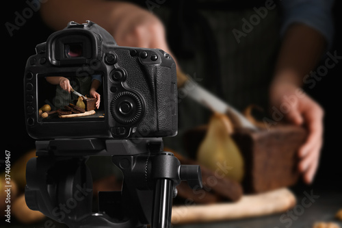 Food photography. Shooting of woman cutting pear bread, focus on camera