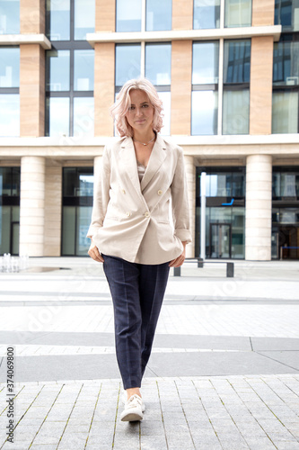 Portrait of a young business woman in business clothes, against the background of the business center