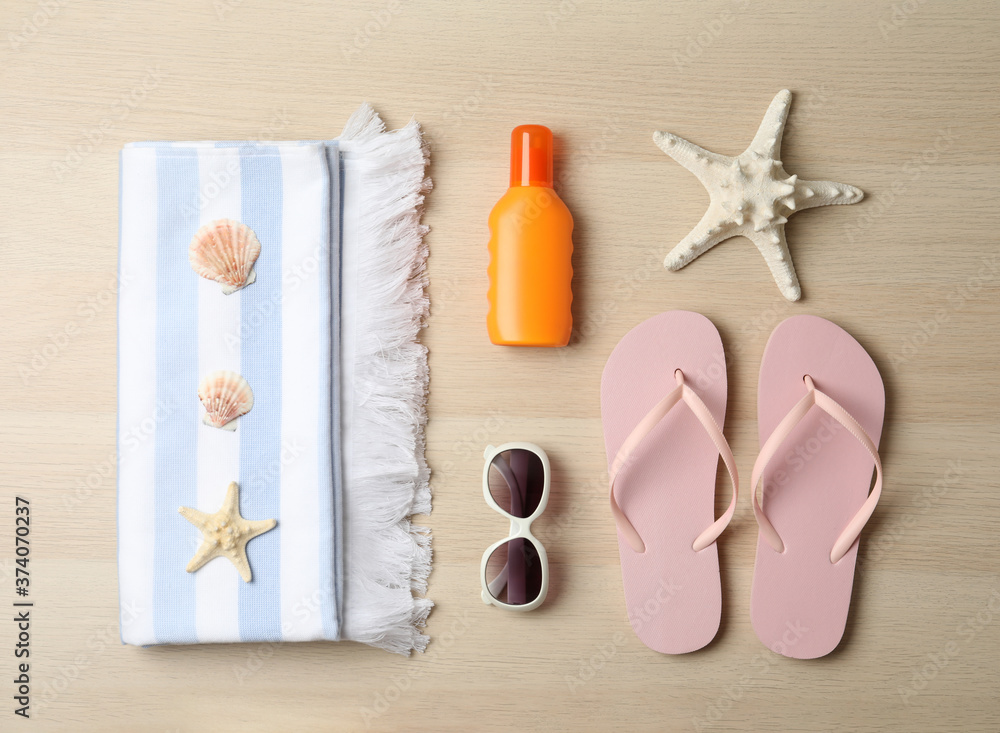 Flat lay composition with beach objects on wooden background