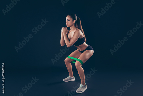 Full size photo of concentrated youth sportive do fitness activity hair brunette hairstyle ponytails isolated over black background