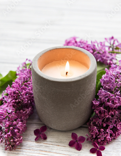 Candle and lilac flowers