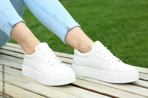 Woman wearing comfortable stylish shoes outdoors, closeup