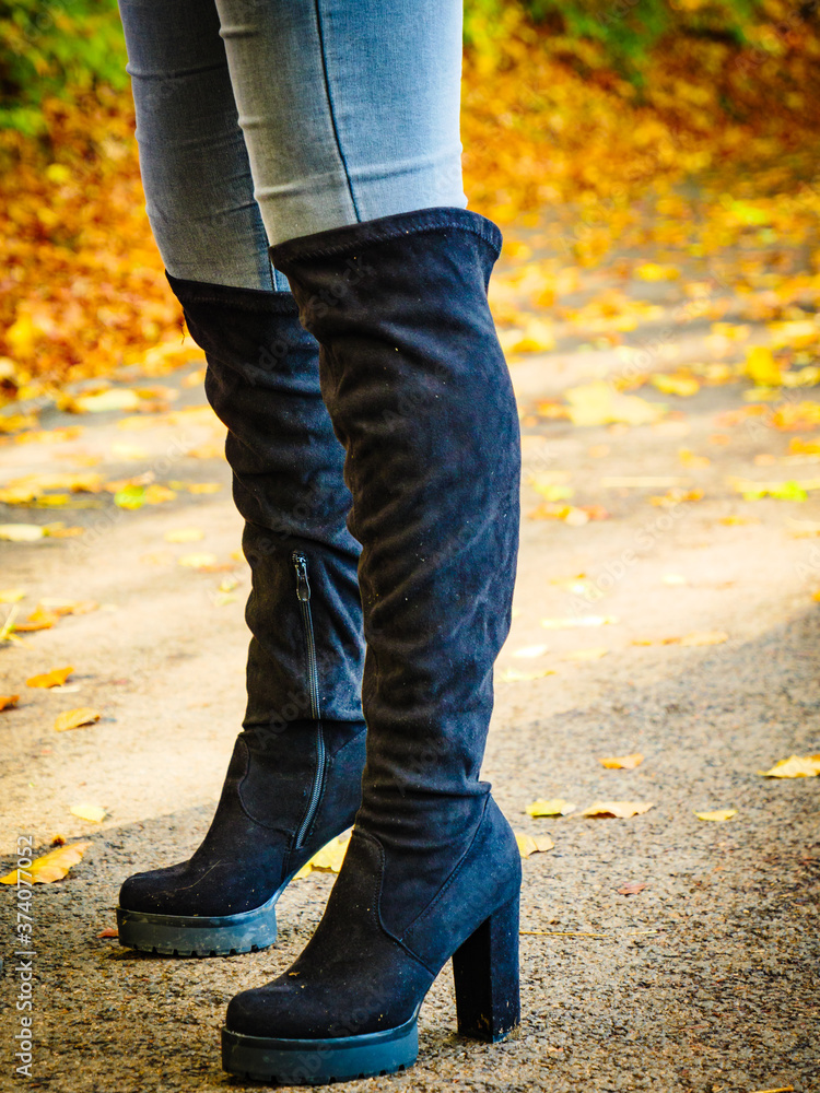 Woman wearing black knee high boots Woman wearing black knee high boots