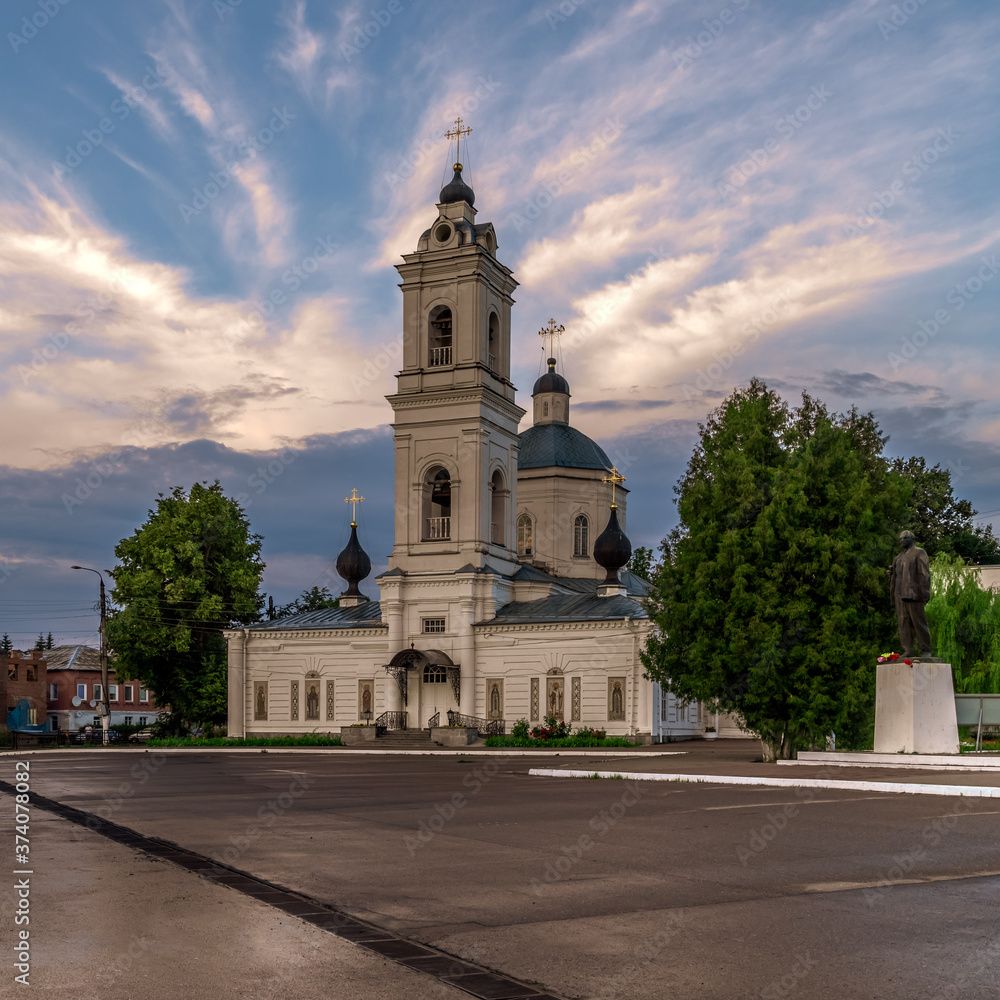 Tarusa, Kaluga region, Russia. Cathedral of St. Peter and Paul on the main square of the city against colourful sunset sky.