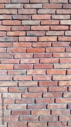 Reddish brickwork with wide cement grouting