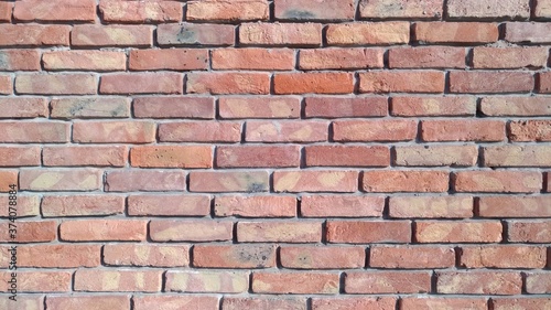 Reddish brickwork with wide cement grouting