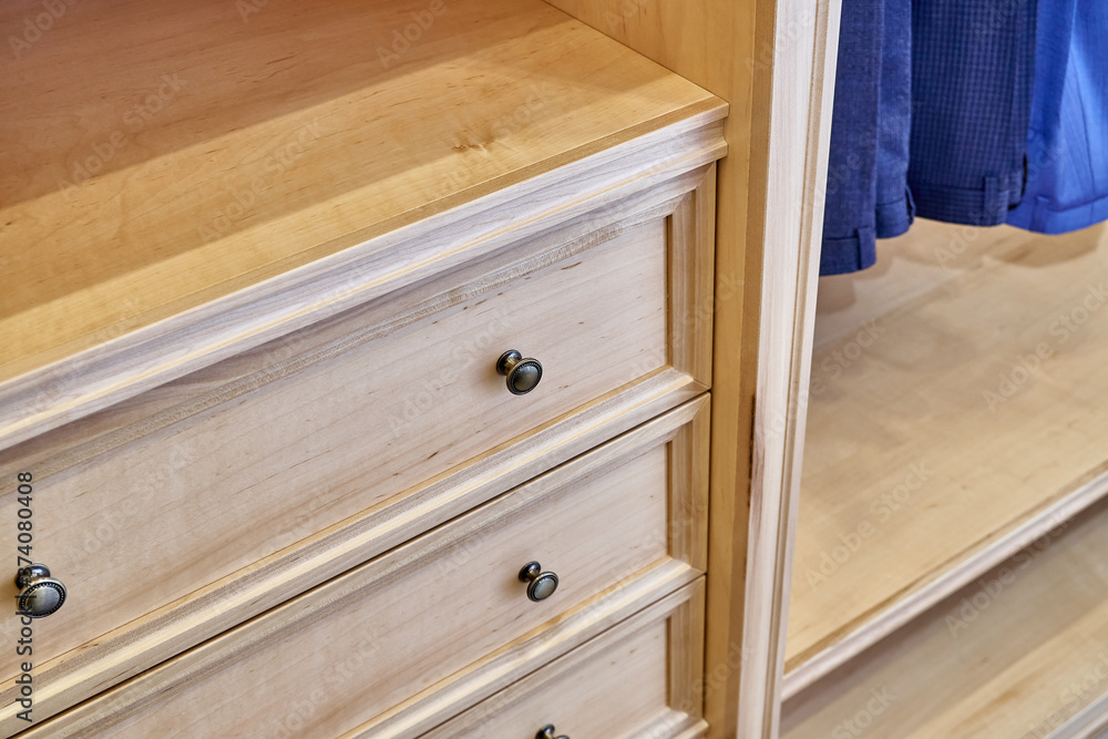 Detail of wardrobe with wooden furniture in dressing room Detail of wardrobe with wooden furniture in dressing room