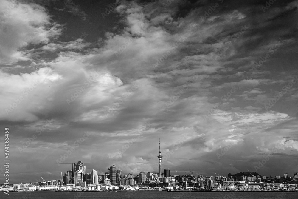 Auckland skyline against big clouds , cityscape New Zealand

