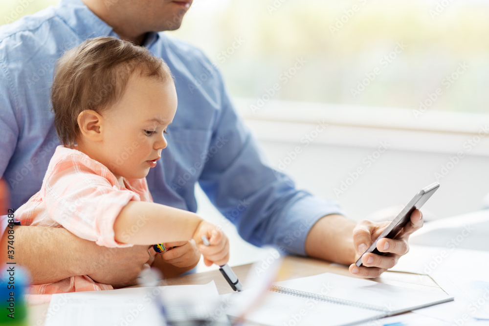 remote job, multi-tasking and family concept - middle-aged father with baby and smartphone working at home office remote job, multi-tasking and family concept - middle-aged father with baby and smartphone working at home office