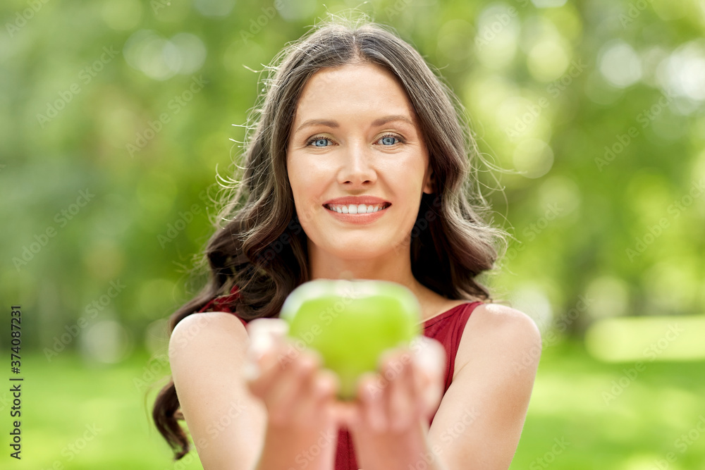 eco living, healthy eating and people concept - portrait of happy woman with green apple at summer park eco living, healthy eating and people concept - portrait of happy woman with green apple at summer park