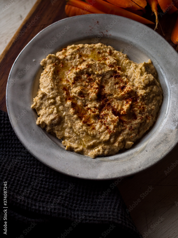 Chickpea hummus home made in natural light on farm table. Chickpea hummus home made in natural light on farm table.