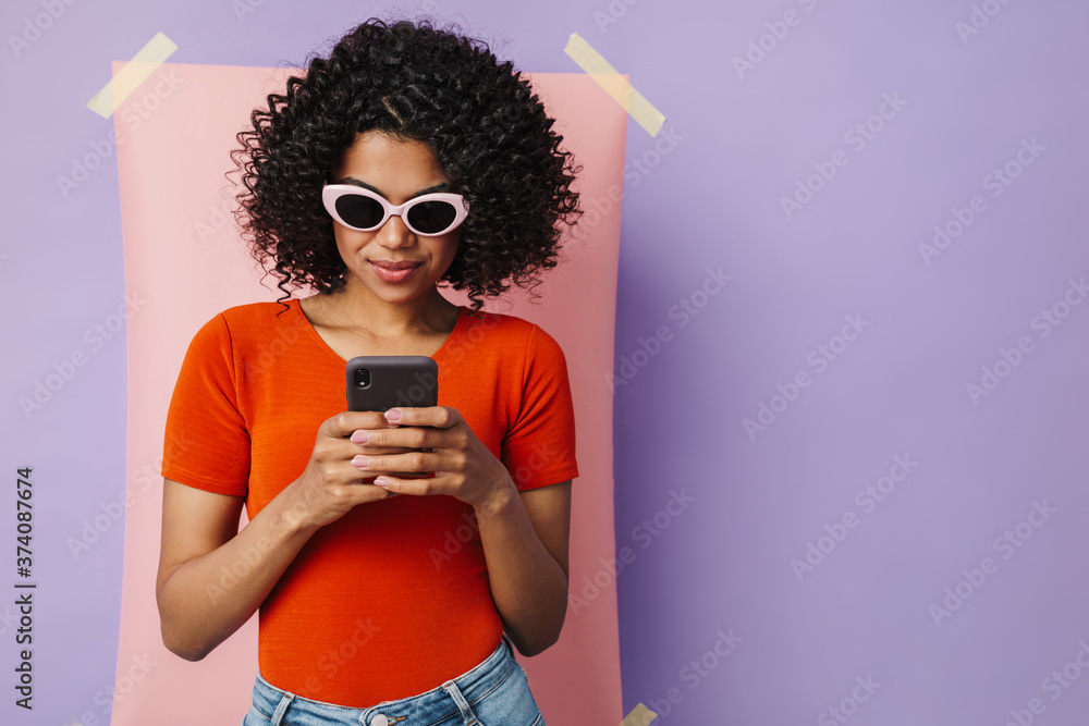 Image of serious african american woman using mobile phone Image of serious african american woman using mobile phone