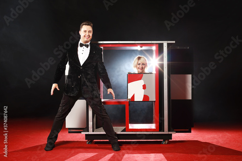 Slika na platnu Magician performer and beauty girl show trick with box illusion on the ring in c