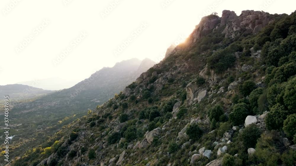 4K Aerial view of rocky mountainous landscape with green leafy forests with magnificent mountains in the distance. 4K Aerial view of rocky mountainous landscape with green leafy forests with magnificent mountains in the distance.