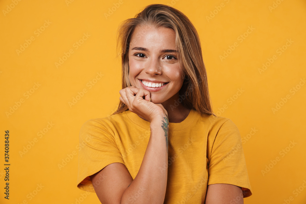 Image of blonde joyful woman smiling and looking at camera Image of blonde joyful woman smiling and looking at camera