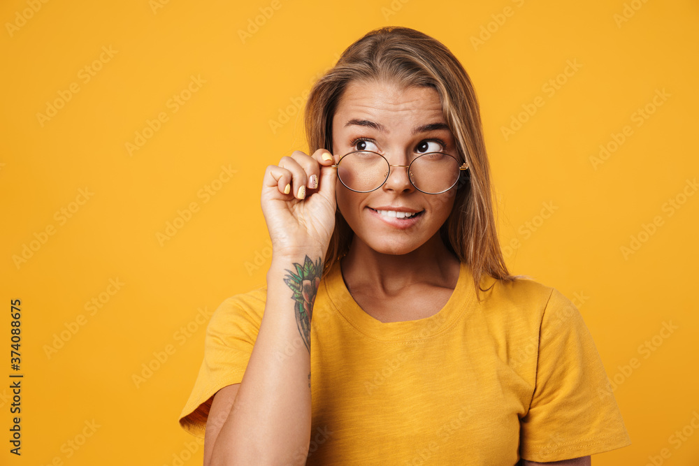 Image of blonde surprised woman in eyeglasses looking aside Image of blonde surprised woman in eyeglasses looking aside