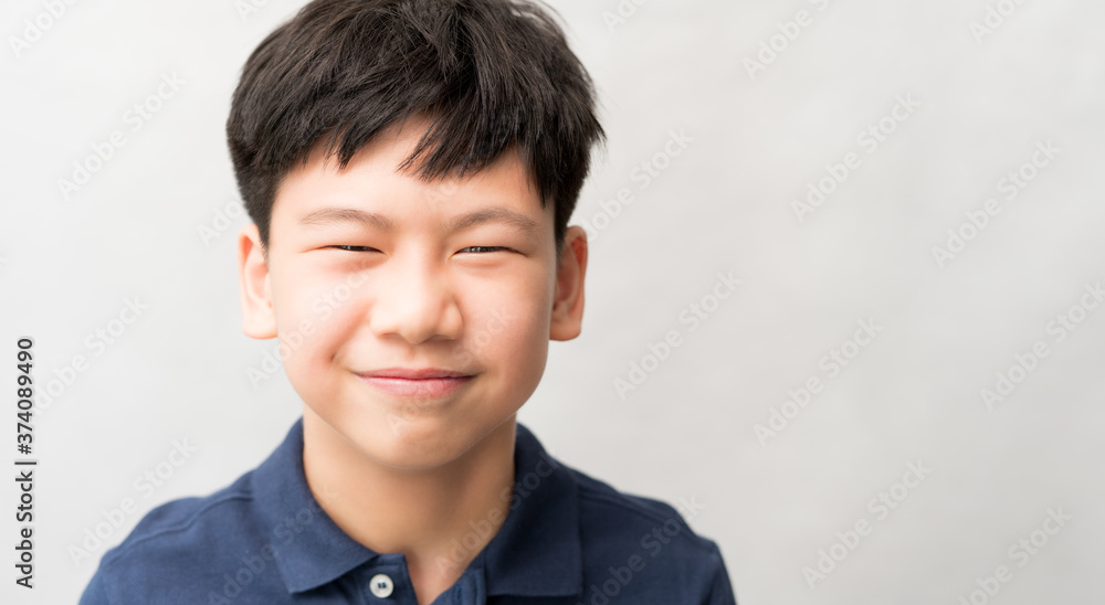 Portrait of handsome and smart looking Asian preteen boy smiling with confident and happy face expression. Healthy early adolescence development concept (physical, mental and emotional) . Portrait of handsome and smart looking Asian preteen boy smiling with confident and happy face expression. Healthy early adolescence development concept (physical, mental and emotional) .