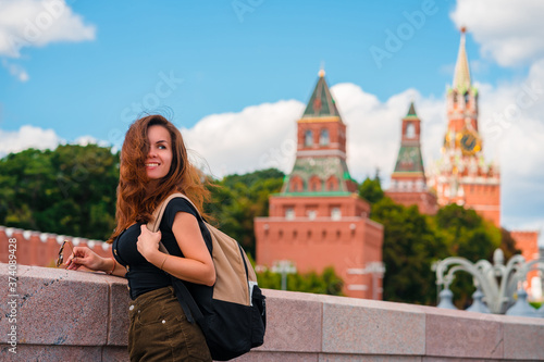 Portrait of a beautiful young female tourist with a view of the Kremlin in Moscow, Russia © KseniaJoyg