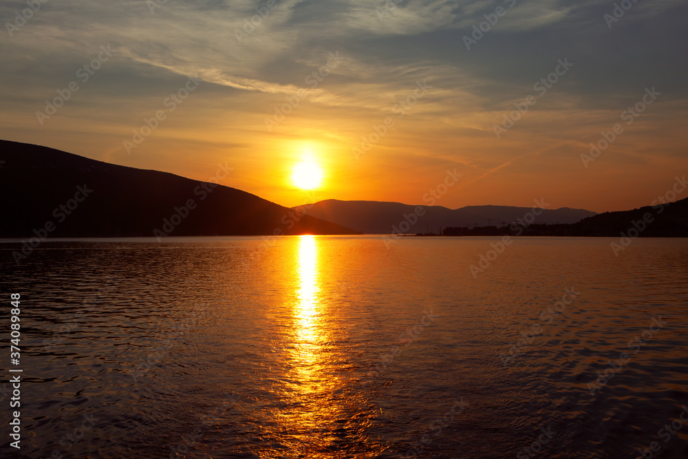 Awesome Sunset Over the Bay . Sunlight reflection in the sea water . Sailing in the dusk Awesome Sunset Over the Bay . Sunlight reflection in the sea water . Sailing in the dusk