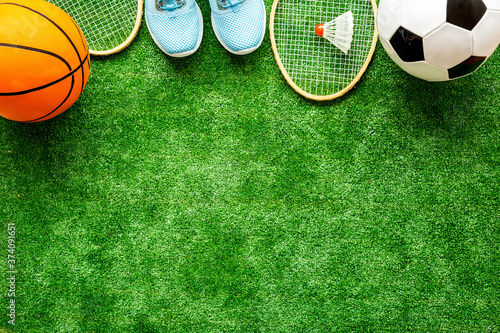 Flat lay of sport balls - football, basketball on grass. Top view copy space © 9dreamstudio
