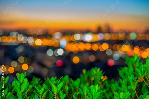 abstract background of the green leaves in the park,with the blur of bokeh,the light from the colorful shelter falling onto,a kind of artistic beauty of nature © bangprik