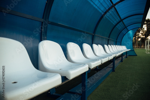 Coach and reserve benches in a soccer field photo