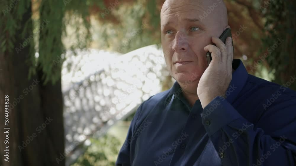 Image with a Man on the Street Trying to Make a Phone Call Using a Smartphone Image with a Man on the Street Trying to Make a Phone Call Using a Smartphone