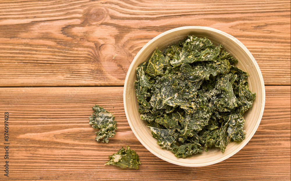 Kale chips on a wooden table. Copy space Kale chips on a wooden table. Copy space