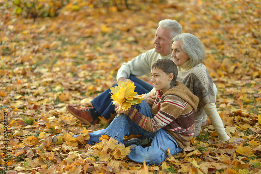 Happy grandfather, grandmother and grandson in park Happy grandfather, grandmother and grandson in park
