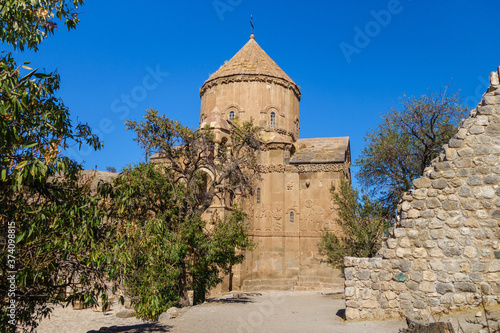 Medieval Armenian Cathedral of Holy Cross   its park  Akdamar island  Van Lake  Geva   Turkey. Walls are richly decorated by bas-reliefs from Bible   Gospel. Church built in 921 for kings of Vaspurakan