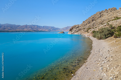 South coastline of Akdamar Island on Van Lake, Gevaş, Turkey. Clear water & its very bright blue colour created by soda elements in its consist. It's popular tourist destination among locals & foreign