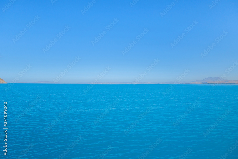 Panoramic view onto Van Lake, near Gevaş, Turkey. Bright blue colour of water created by soda elements. This is most biggest saline soda lake in world