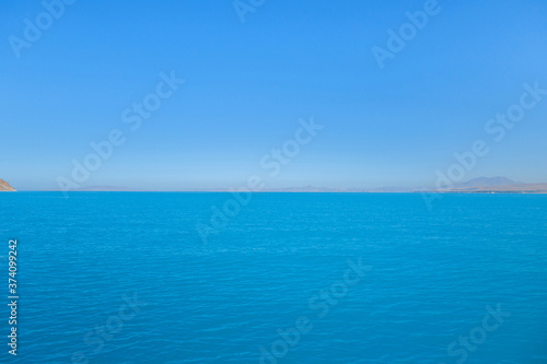Panoramic view onto Van Lake, near Gevaş, Turkey. Bright blue colour of water created by soda elements. This is most biggest saline soda lake in world