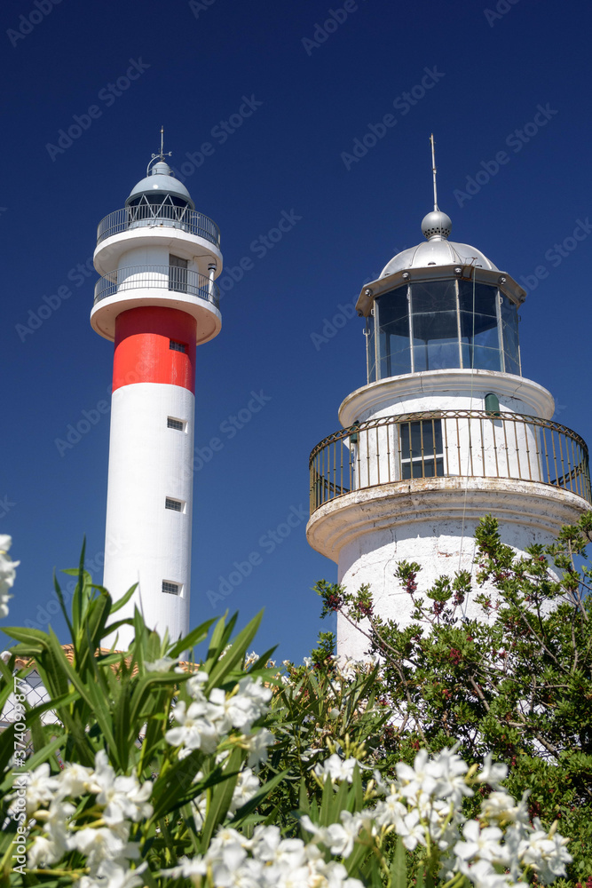Two lighthouses together on the Spanish coast. The ancient and the modern together. Sunny day in El Rompido, Huelva, Andalusia, Spain Two lighthouses together on the Spanish coast. The ancient and the modern together. Sunny day in El Rompido, Huelva, Andalusia, Spain