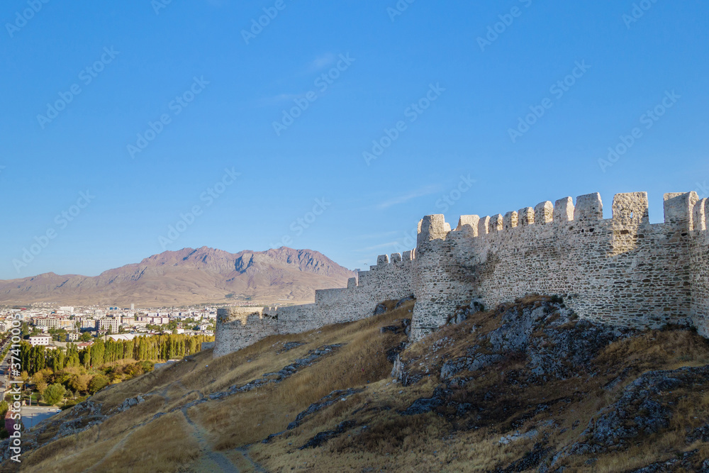 Massive fortifications of Van Fortress, Van, Turkey. It was founded in 9 century BC by Urartians & reinforced by Turks. Now it's favorite place for walking among tourists. Modern Van is on background