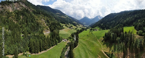 Panorama of the passeier valley with the passeier river and mountains in perspective.