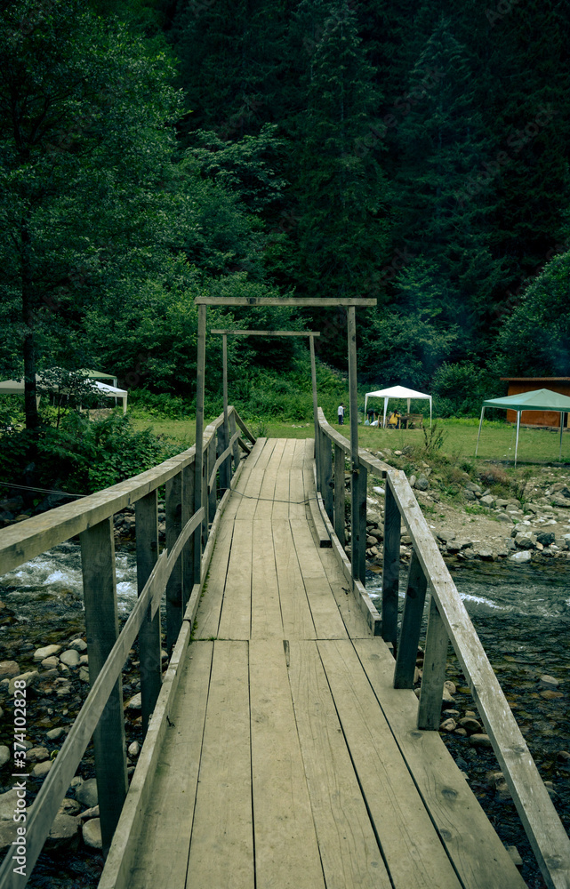 wooden bridge over the river in the woods wooden bridge over the river in the woods
