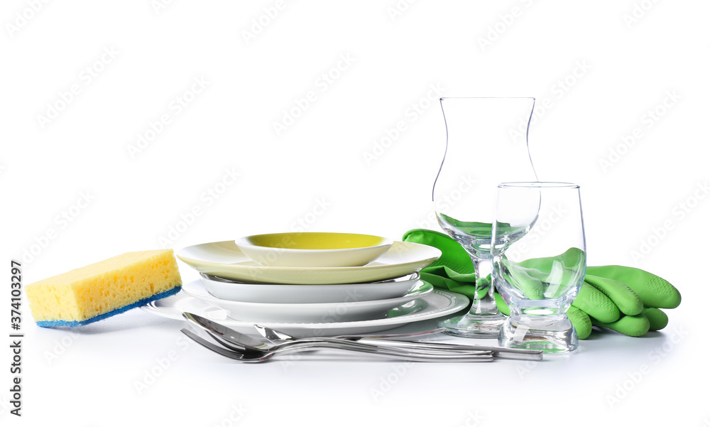 Clean tableware with sponge and gloves on white background Clean tableware with sponge and gloves on white background
