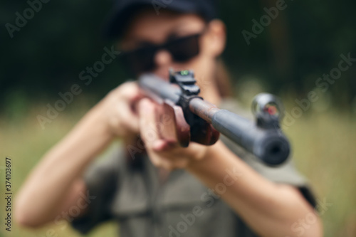 Woman on outdoor muzzle of the gun sight hunting weapons