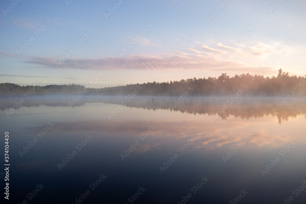 Calm morning water reflection in the Schoenramer Filz Moor, South Germany