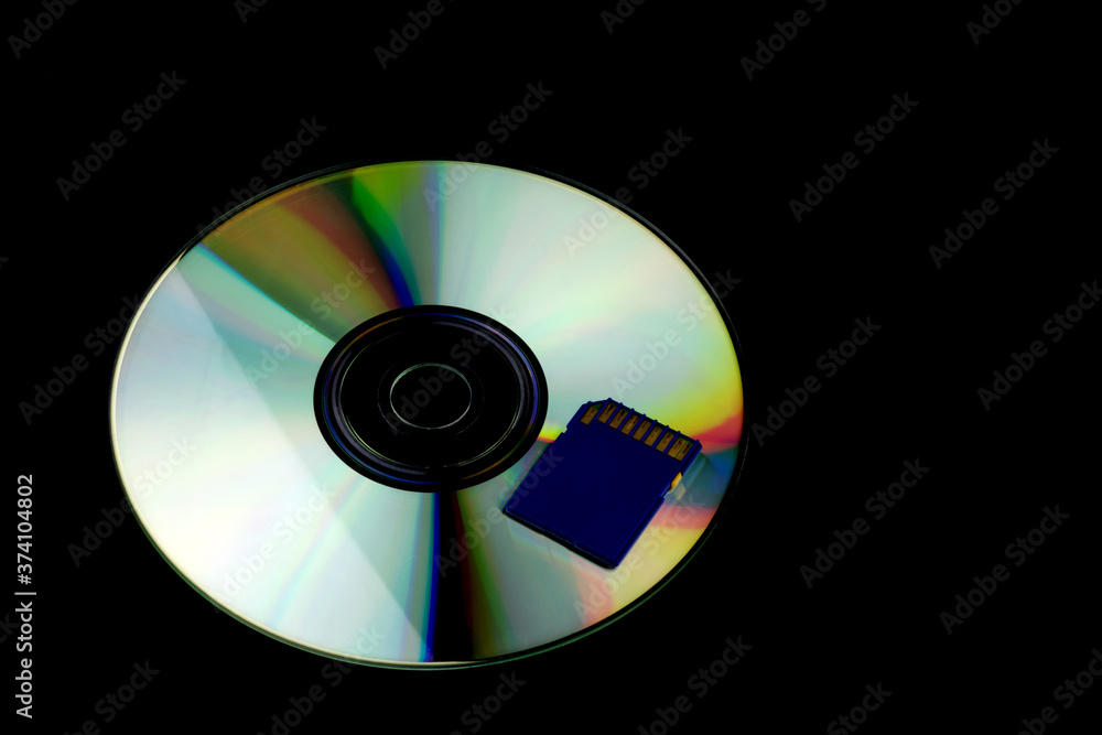 Compact Disc and Memory Card on a Black Background Compact Disc and Memory Card on a Black Background