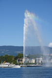 the water jet fountain and an old steam boat on lake Geneva, switzerland