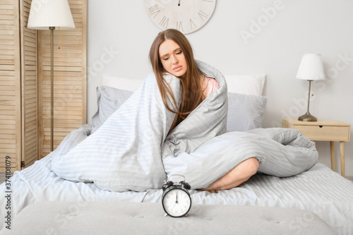 Young woman with alarm cloc...