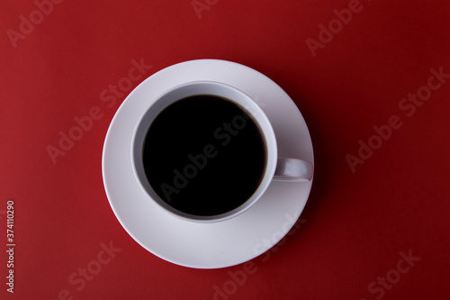  Expresso coffee in a white cup on a red background, minimalism, close-up 