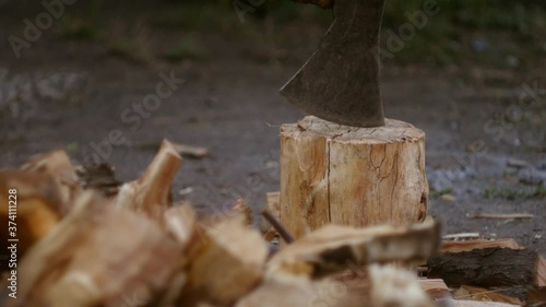 Wallpaper Mural Chops logs with axe close up. Making firewood.  Torontodigital.ca