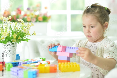 Portrait of girl playing with colorful plastic blocks