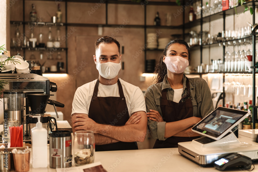 Coffee shop owners with face masks, lockdown, quarantine, coronavirus, back to normal concept Coffee shop owners with face masks, lockdown, quarantine, coronavirus, back to normal concept