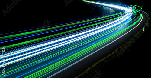 green, blue and white car lights on the road at night